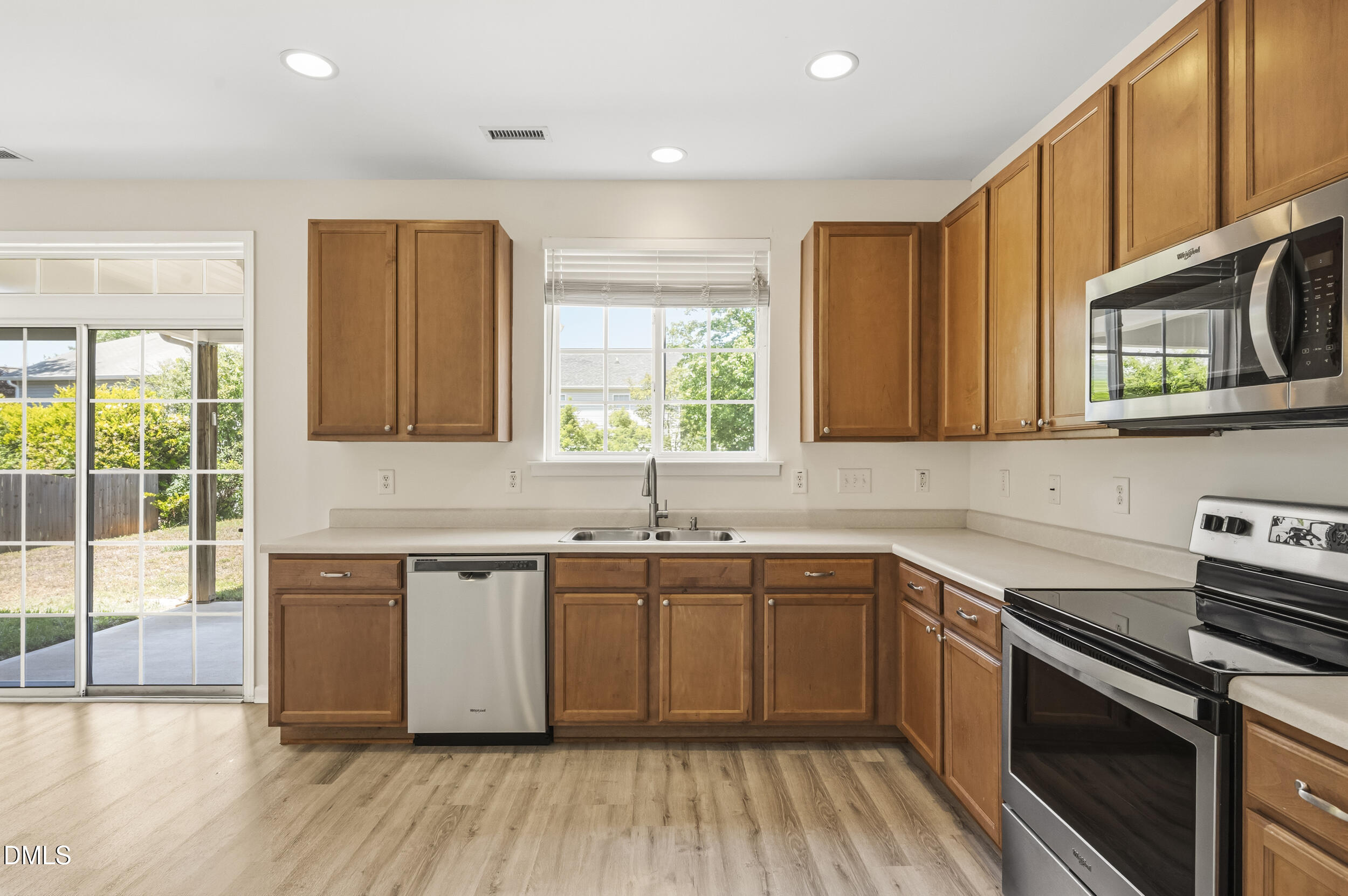 112 Ryder Cup Circle Raleigh, NC 27603 - Photo 11 of 45 a kitchen with stainless steel appliances granite countertop wooden cabinets a sink and a stove