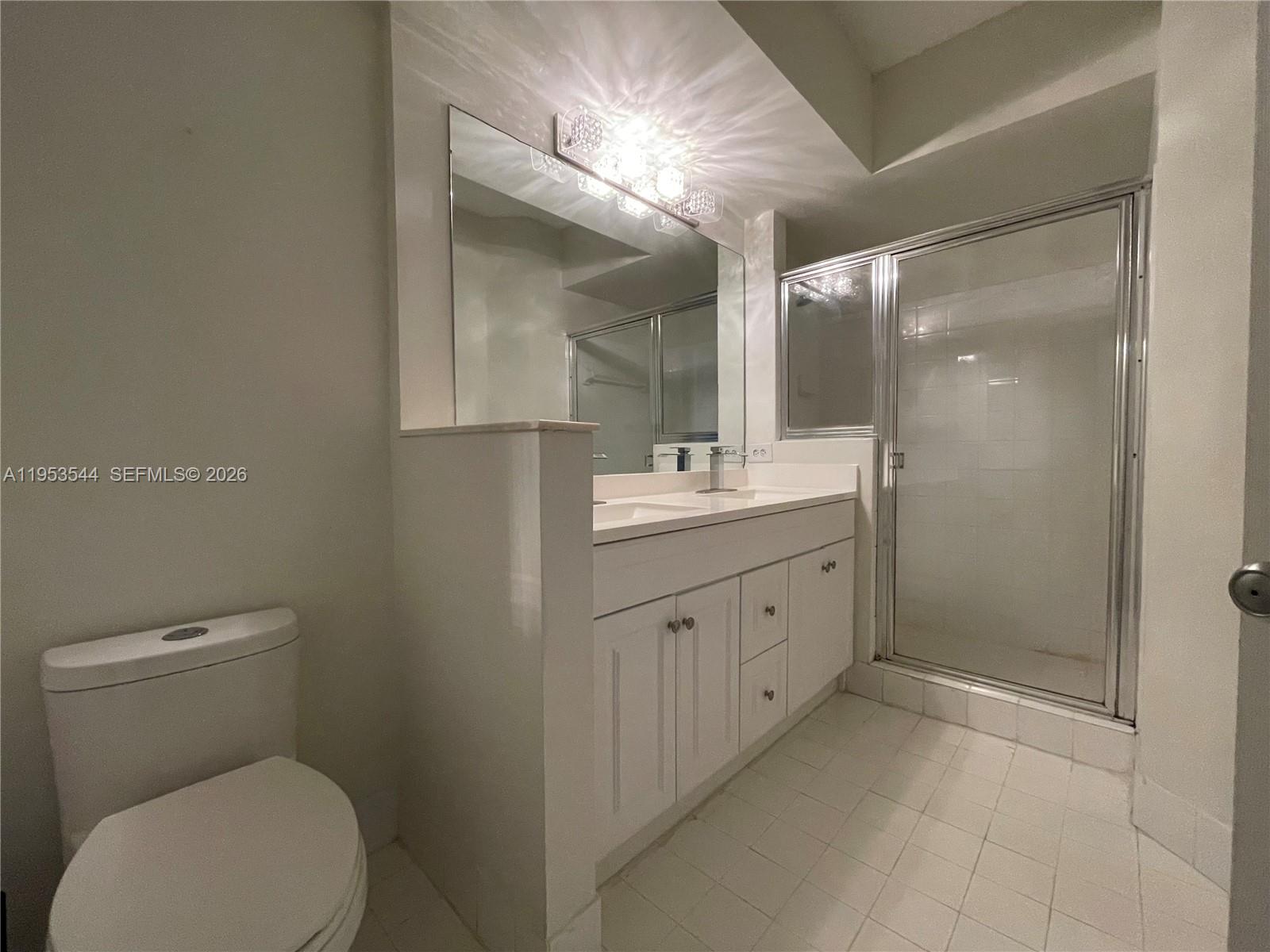 17125 North Bay Road, Unit 3404 Sunny Isles Beach, FL 33160 - Photo 12 of 20 a spacious bathroom with a toilet sink and mirror