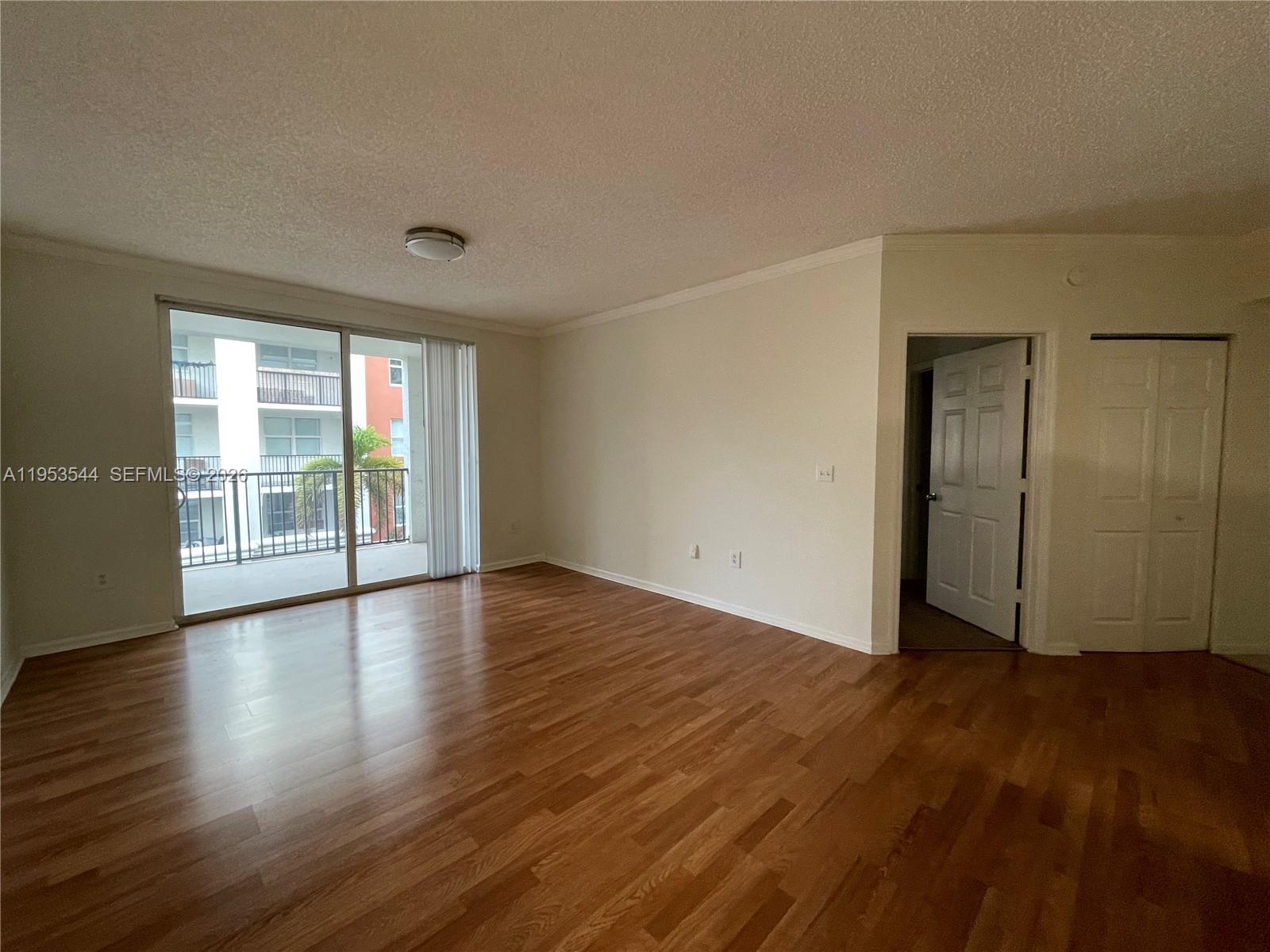 17125 North Bay Road, Unit 3404 Sunny Isles Beach, FL 33160 - Photo 10 of 20 an empty room with wooden floor and windows