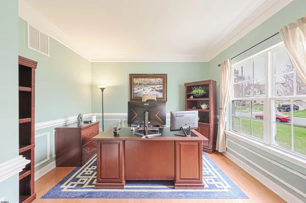 a living room with furniture a rug and a floor to ceiling window
