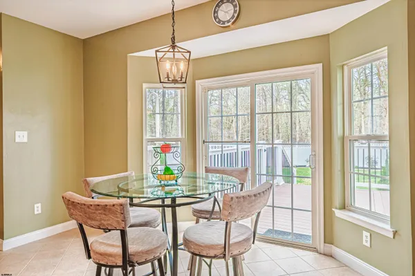 a dining room with furniture a chandelier and wooden floor