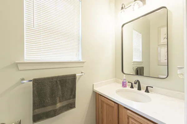 a bathroom with a sink vanity and a mirror