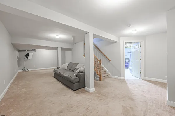 a living room with furniture and a ceiling fan