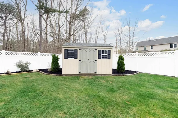 a view of a house with backyard and a tree