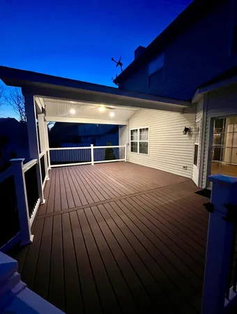 a view of a house with wooden deck