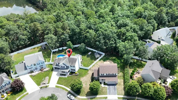 an aerial view of house with outdoor space and swimming pool