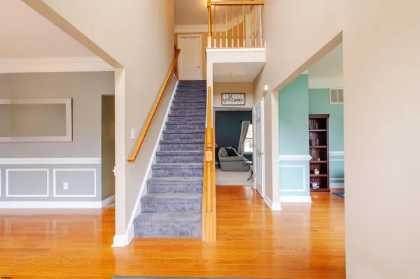 a view of entryway and hall with wooden floor