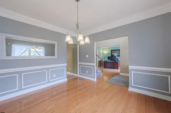 a view of a livingroom with wooden floor fireplace and windows