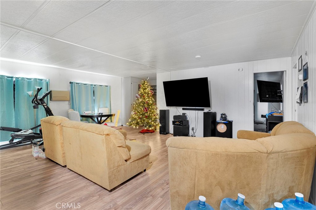 19044 Joshua Street Adelanto, CA 92301 - Photo 11 of 34 a living room with furniture and a flat screen tv