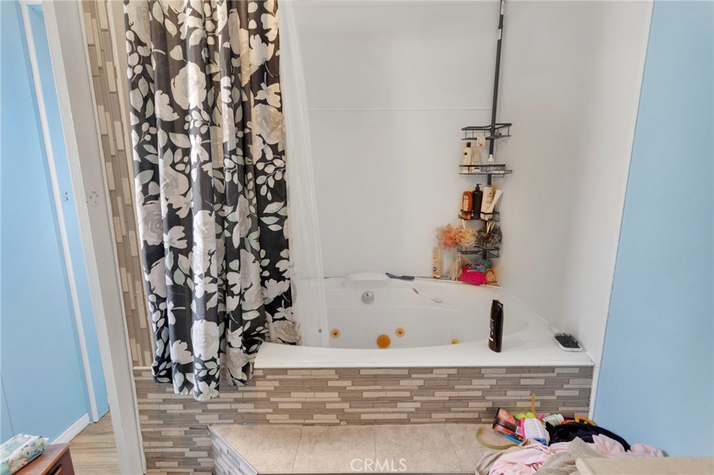 19044 Joshua Street Adelanto, CA 92301 - Photo 15 of 34 a bathroom with a bathtub and shower