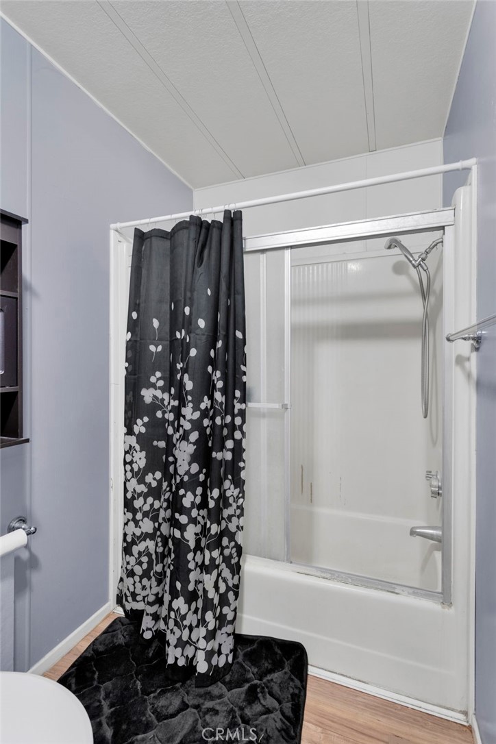 19044 Joshua Street Adelanto, CA 92301 - Photo 17 of 34 a bathroom with a shower curtain and a sink