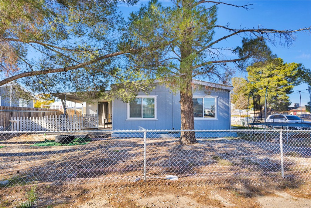 19044 Joshua Street Adelanto, CA 92301 - Photo 4 of 34 a view of a house with a tree in the yard