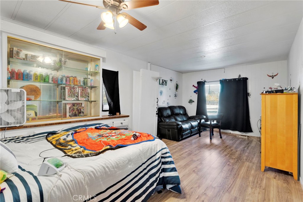 19044 Joshua Street Adelanto, CA 92301 - Photo 6 of 34 a bedroom with a bed and wooden floor