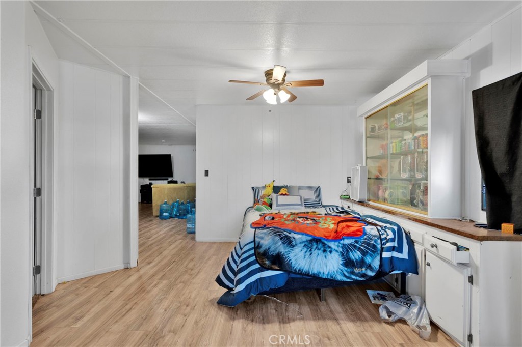 19044 Joshua Street Adelanto, CA 92301 - Photo 7 of 34 a bedroom with furniture and a flat screen tv