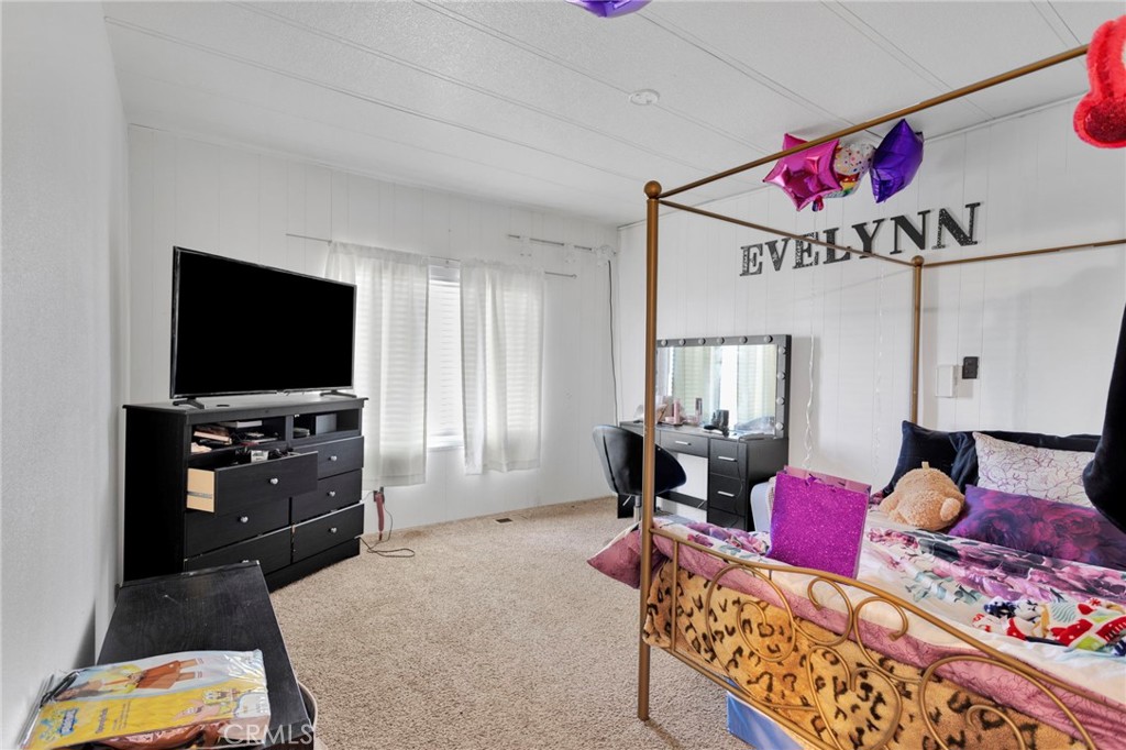 19044 Joshua Street Adelanto, CA 92301 - Photo 8 of 34 a living room with furniture and a flat screen tv