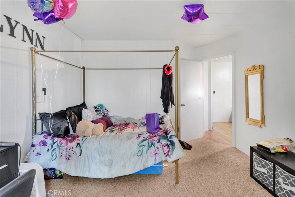19044 Joshua Street Adelanto, CA 92301 - Photo 9 of 34 a bedroom with a bed a couch and dresser
