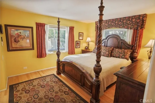 a bed sitting in a bedroom next to a window