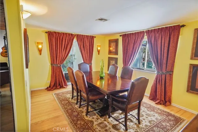 a view of a dining room with furniture and a window