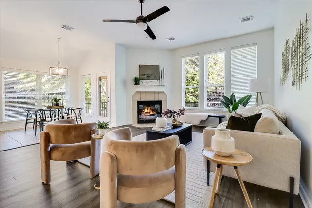 a living room with furniture fireplace and window