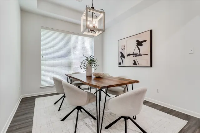 a dining room with furniture and chandelier