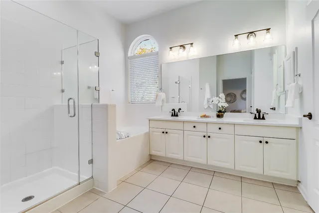 a spacious bathroom with a shower sink and mirror
