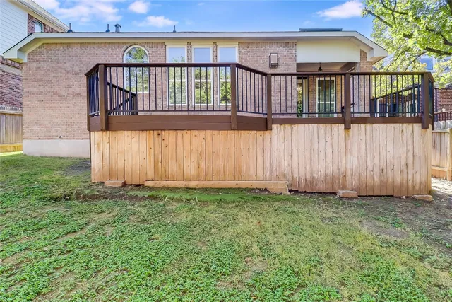 a view of a backyard with wooden fence