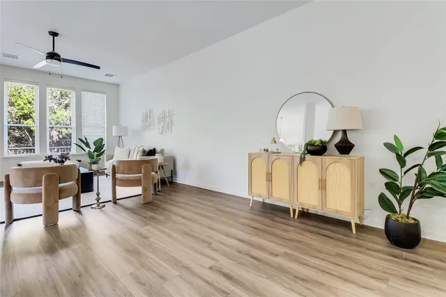 a living room with furniture and a potted plant