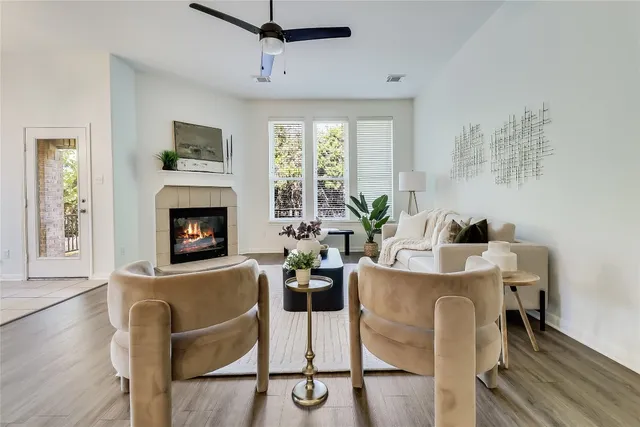 a living room with furniture a window and a fireplace