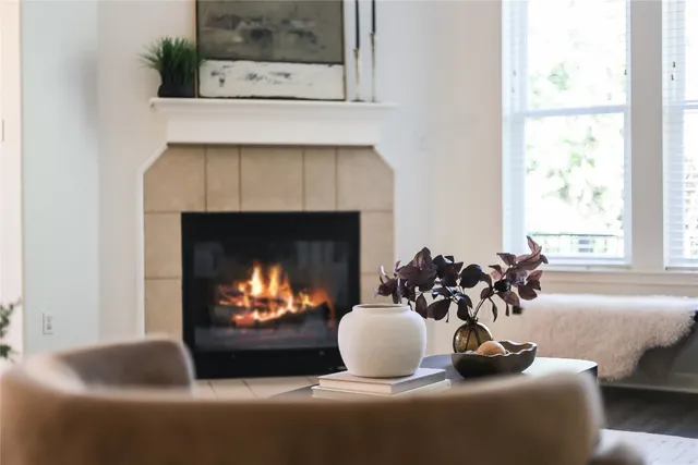 a living room with furniture a fireplace and window