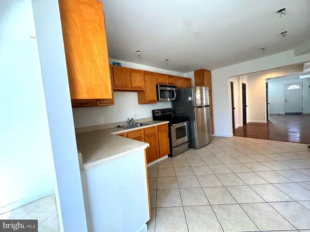 a kitchen with stainless steel appliances granite countertop a sink and a stove top oven