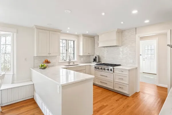 a white toilet sitting next to a bathroom sink and vanity