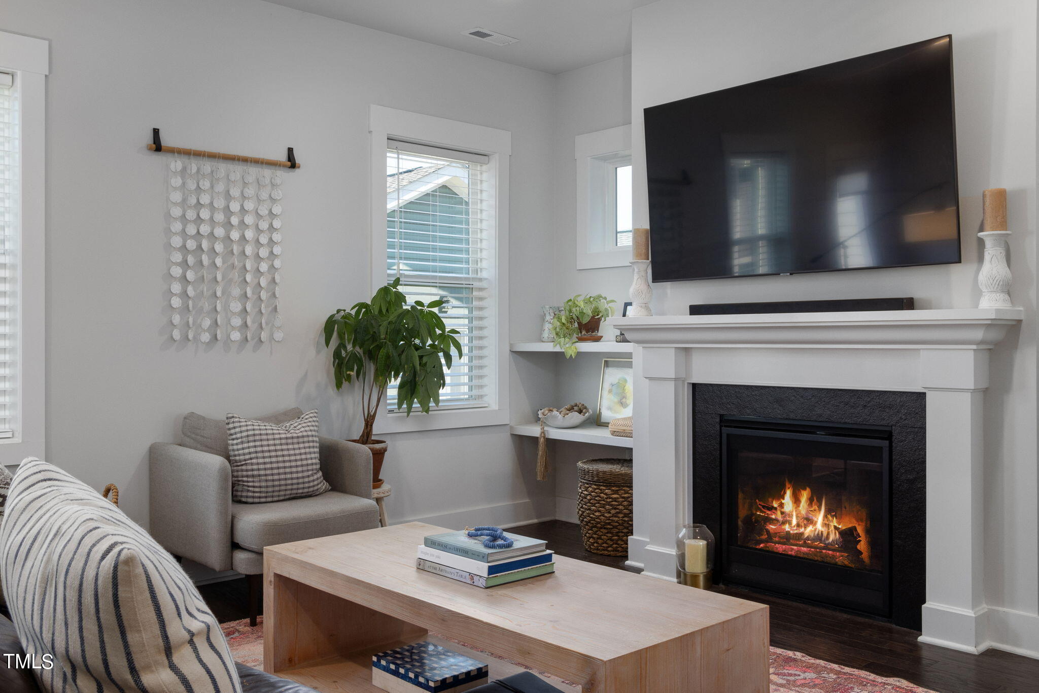 269 Douglas Falls Drive Wendell, NC 27591 - Photo 20 of 51 a living room with furniture a flat screen tv and a fireplace