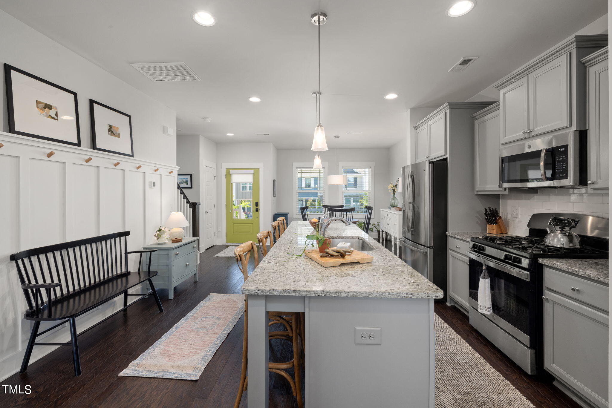 269 Douglas Falls Drive Wendell, NC 27591 - Photo 9 of 51 a kitchen with sink a refrigerator and chairs