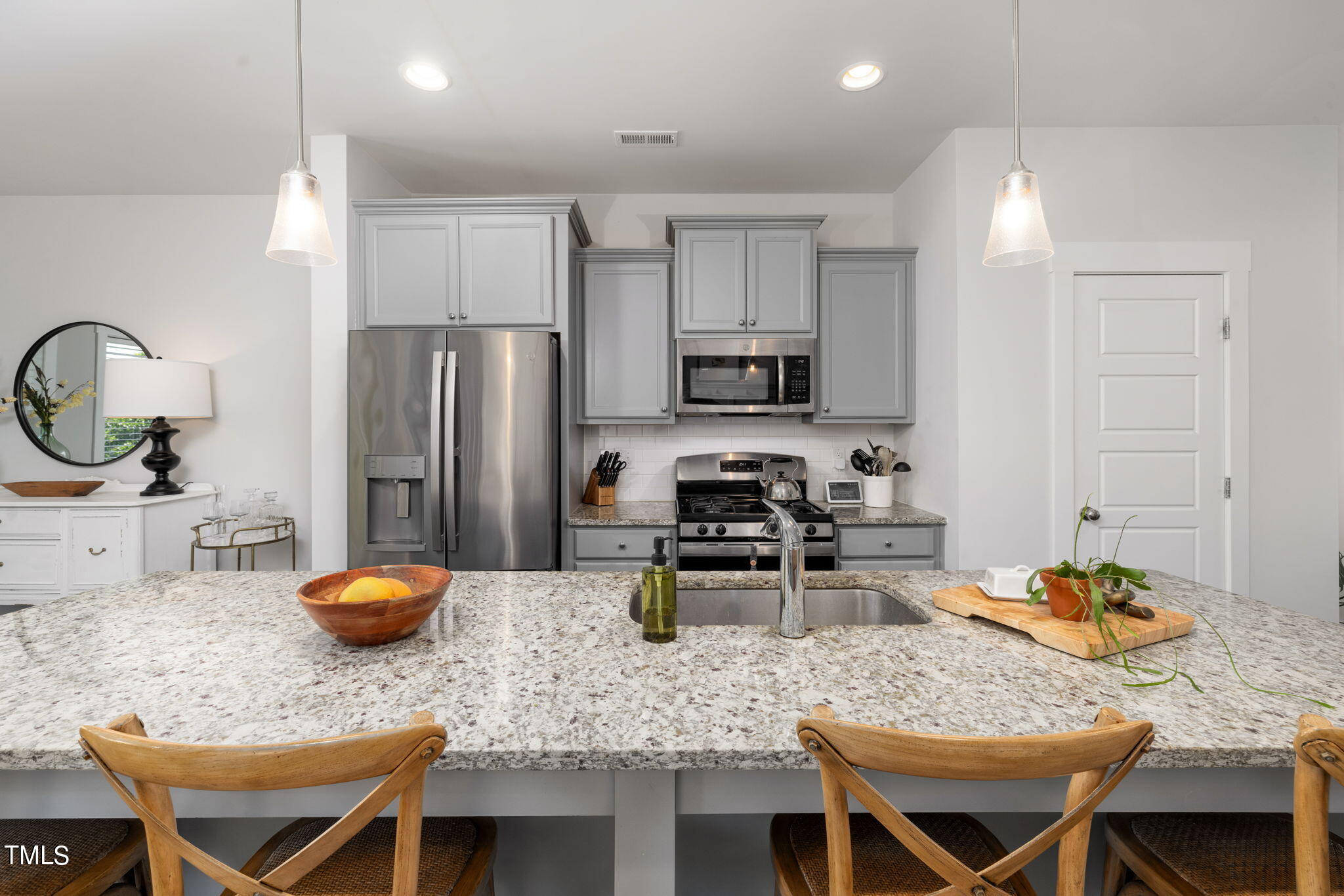 269 Douglas Falls Drive Wendell, NC 27591 - Photo 10 of 51 a kitchen with stainless steel appliances granite countertop a stove a refrigerator a sink a table and chairs