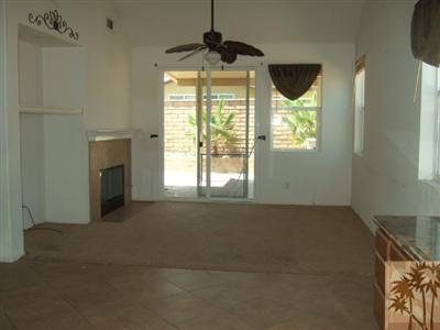 37243 Haweswater Road Indio, CA 92203 - Photo 3 of 14 a furnished livingroom with windows and a fireplace