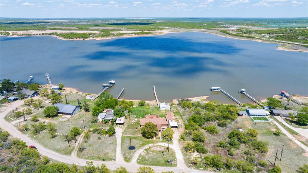 36 Poverty Point Circle Abilene, TX 79601 - Photo 2 of 31 a view of a lake with a table and chairs