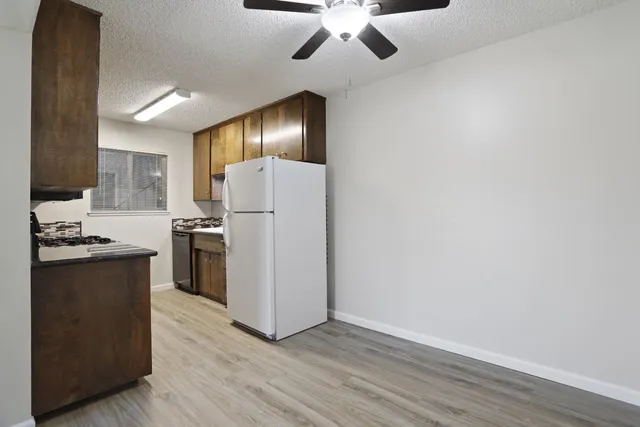 a kitchen with a refrigerator and a stove