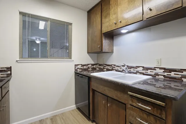 a view of a kitchen that has a sink and a stove