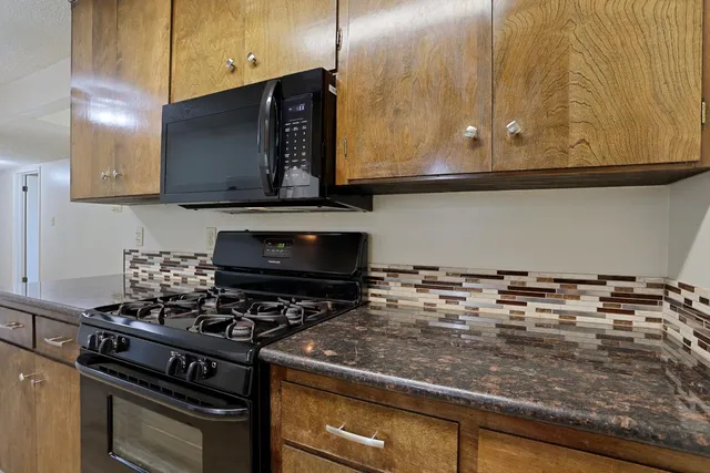 a kitchen with a stove and a microwave