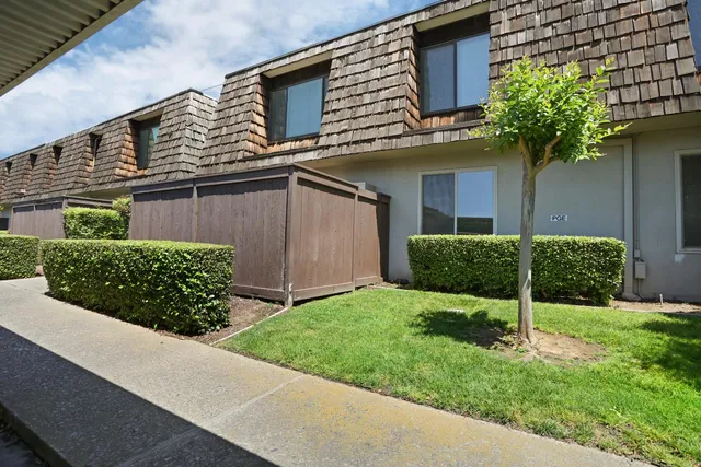 a view of a house with a yard and plants