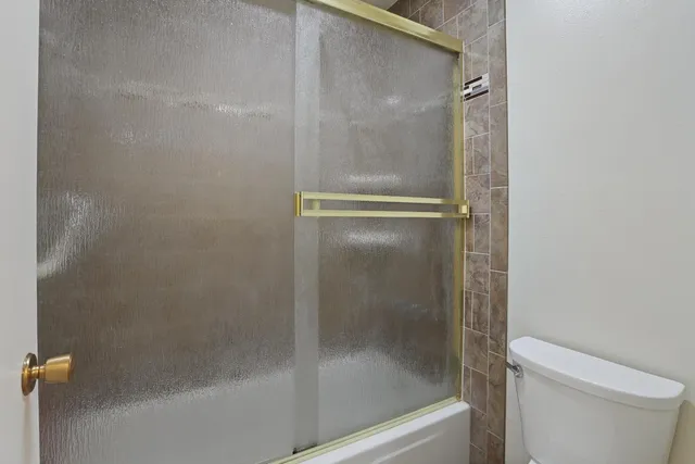 a bathroom with a glass shower door