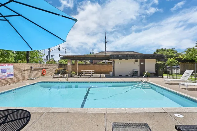 an outdoor space with pool and furniture