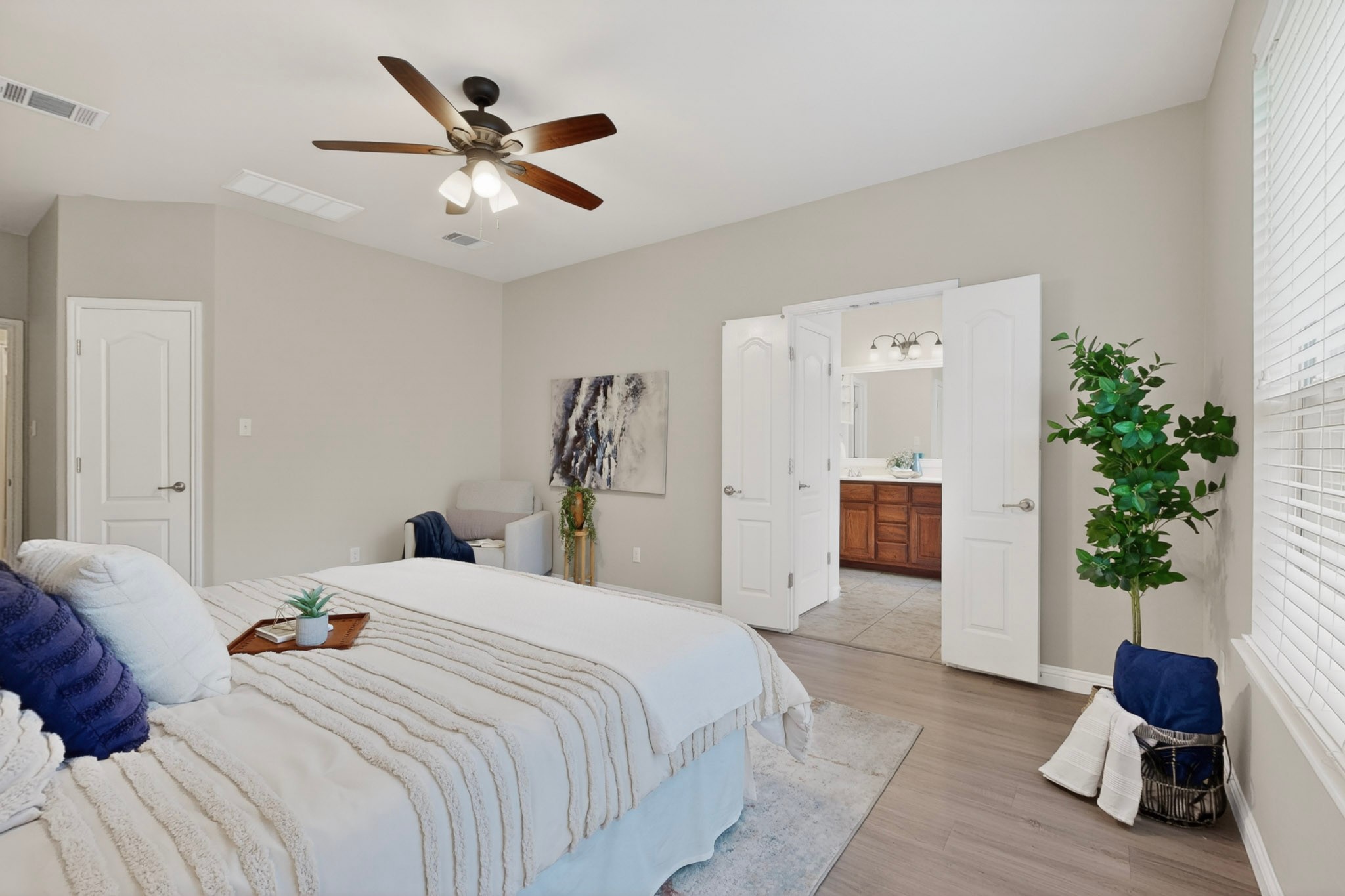 178 Limestone Trail Austin, TX 78737 - Photo 21 of 40 Spacious bedroom featuring wood-finish flooring, a ceiling fan with light fixture, and neutral wall tones