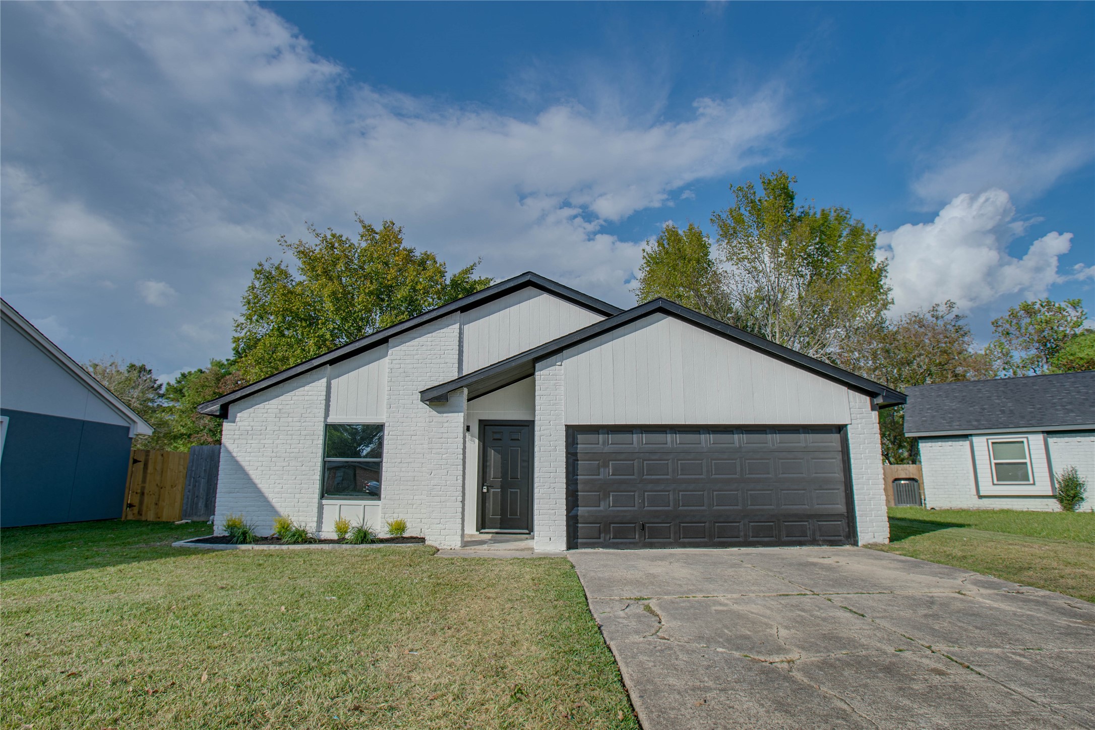 a front view of a house with a garden and yard