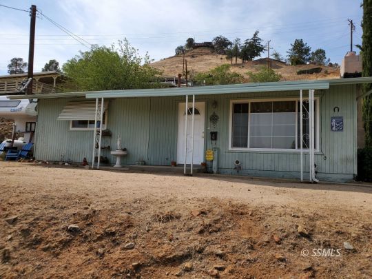 77 Adams Road Wofford Heights, CA 93285 - Photo 21 of 22 a house with trees in the background