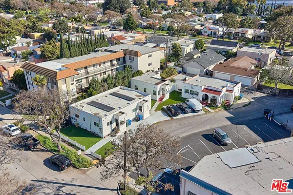 a kitchen with stainless steel appliances kitchen island granite countertop a stove and white cabinets