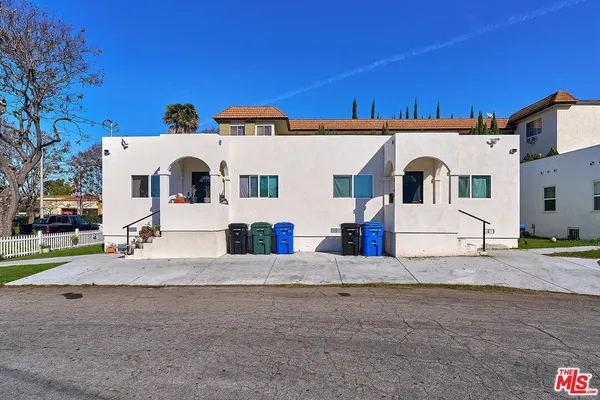 a view of a white house with a yard