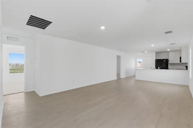 a view of a kitchen with a sink and a refrigerator