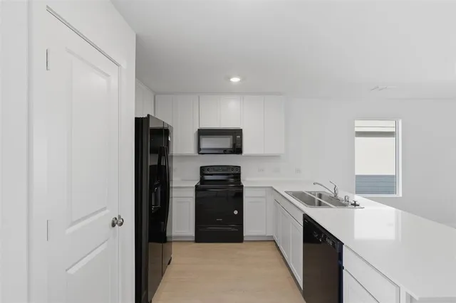 a kitchen with a refrigerator and a sink
