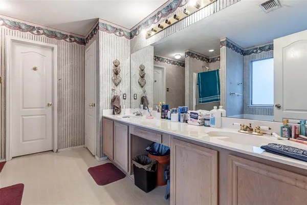 a bathroom with a double vanity sink mirror and double
